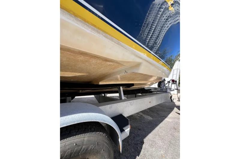 Slide: The Image of 2008 Donzi 38 ZFX Open boat on trailer, showing hull and tire detail. - 20