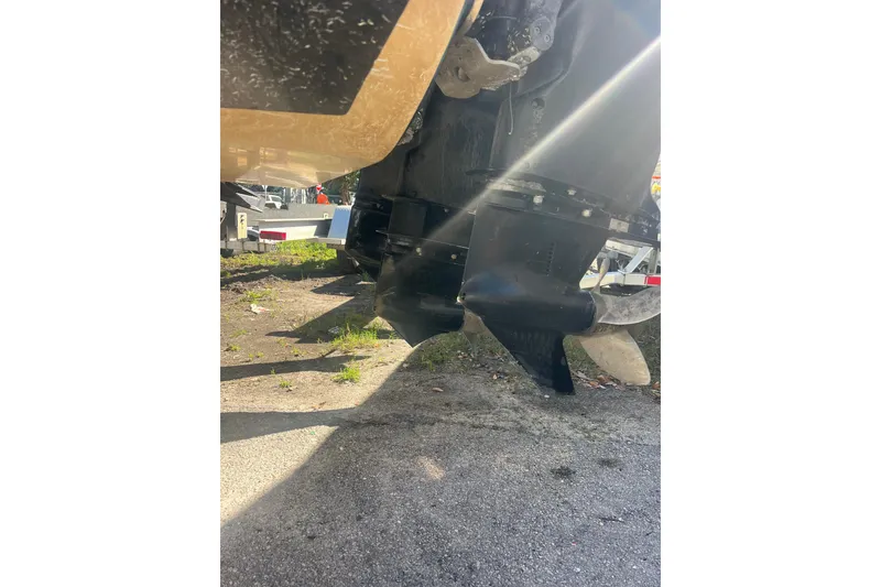 Slide: The Image of 2008 Donzi 38 ZFX Open boat propellers in sunlight, parked on pavement. - 24