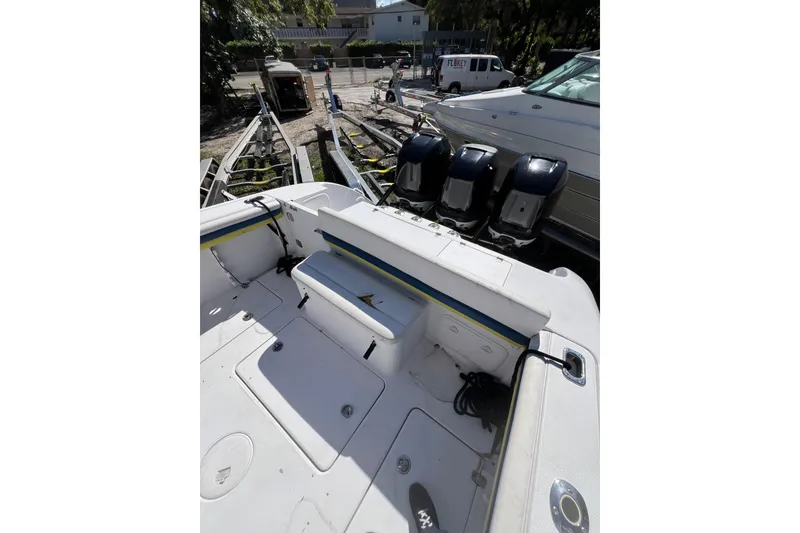 Slide: The Image of 2008 Donzi 38 ZFX Open boat with triple outboard engines, docked in a marina. - 34