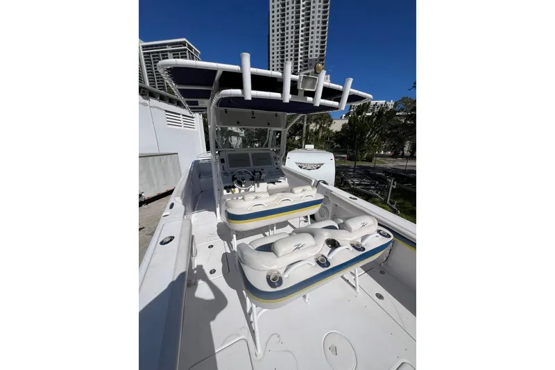 Slide: The Image of 2008 Donzi 38 ZFX Open boat with seating and control panel, docked outdoors. - 35
