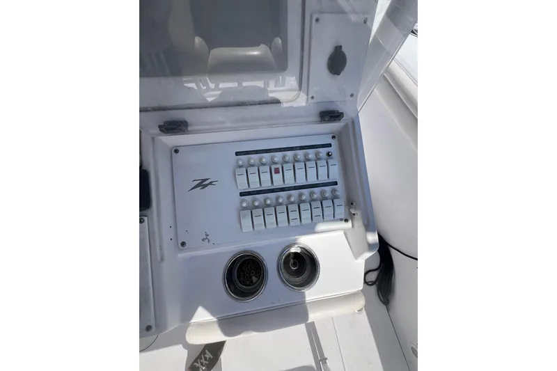 Slide: The Image of Control panel of a 2008 Donzi 38 ZFX Open boat with switches and outlets. - 37