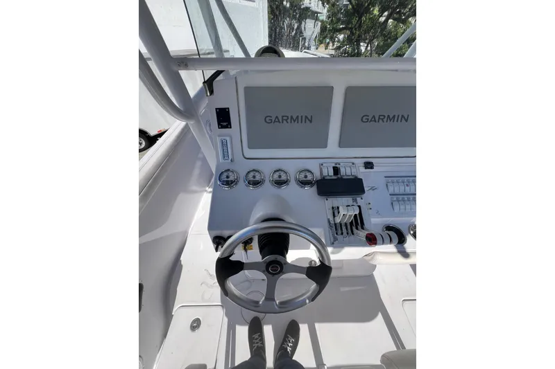 Slide: The Image of 2008 Donzi 38 ZFX Open boat dashboard with Garmin displays and steering wheel. - 39