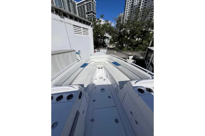 Slide: The Image of 2008 Donzi 38 ZFX Open boat with spacious seating, docked near urban buildings. - 42