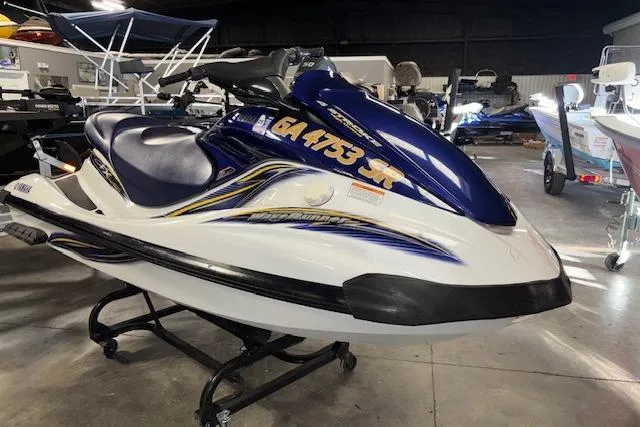 The Image of 2004 Yamaha WaveRunner FX jet ski in showroom, blue and white design. - 1