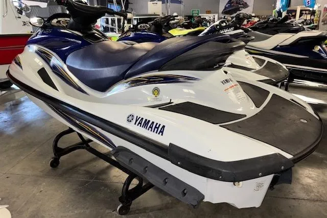 Slide: The Image of 2004 Yamaha WaveRunner FX jet ski in showroom, white and blue design. - 3