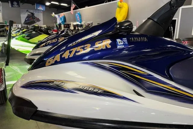 Slide: The Image of 2004 Yamaha WaveRunner FX jet ski in showroom, blue and white design. - 5