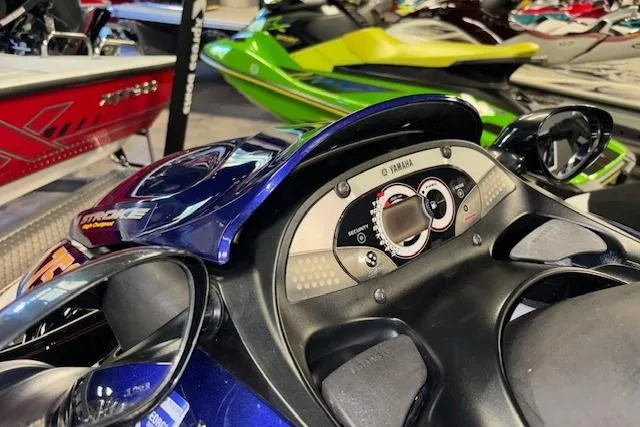 Slide: The Image of 2004 Yamaha WaveRunner FX dashboard with controls, surrounded by other watercraft. - 12