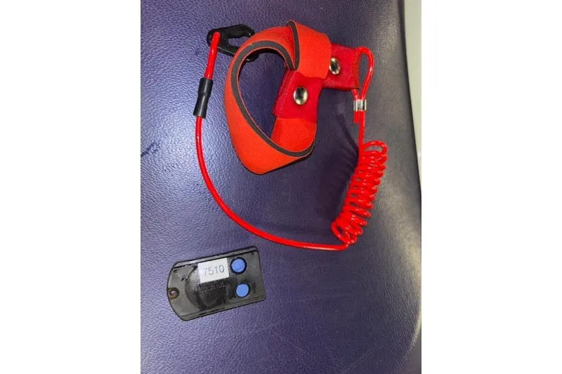 Slide: The Image of Red safety lanyard and key for 2004 Yamaha WaveRunner FX on a dark surface. - 15