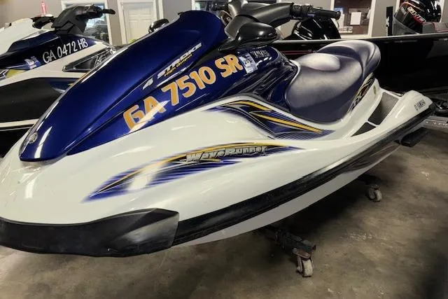 Slide: The Image of 2004 Yamaha WaveRunner FX jet ski in showroom, blue and white design. - 3