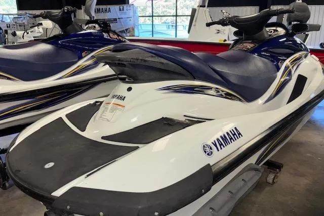 Slide: The Image of 2004 Yamaha WaveRunner FX jet ski in showroom, white and blue design. - 8