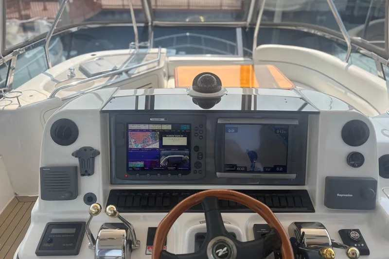 Slide: The Image of Helm of 2006 Sea Ray 52 Sedan Bridge with navigation screens and controls. - 12