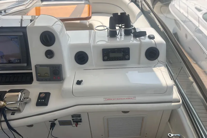 Slide: The Image of 2006 Sea Ray 52 Sedan Bridge helm with navigation equipment and binoculars. - 15