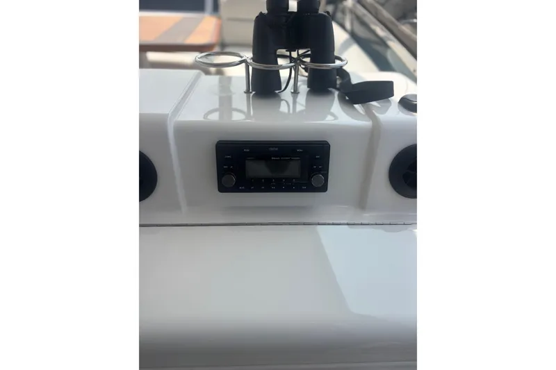 Slide: The Image of Control panel of a 2006 Sea Ray 52 Sedan Bridge yacht with stereo system and binoculars. - 16