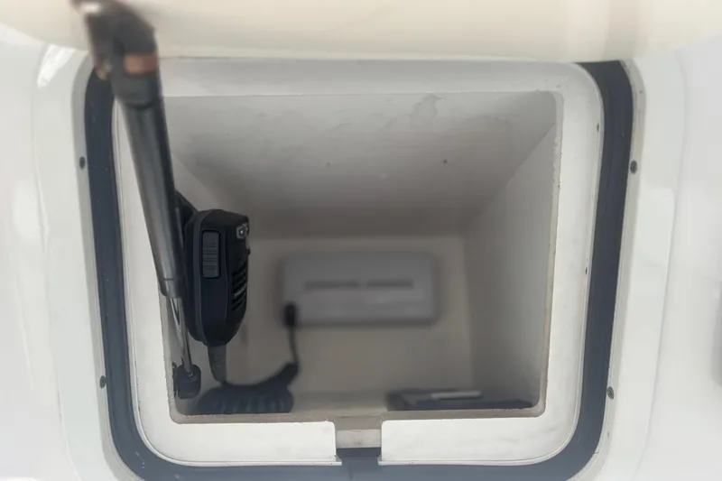 Slide: The Image of Storage compartment with a radio handset on a 2006 Sea Ray 52 Sedan Bridge yacht. - 17
