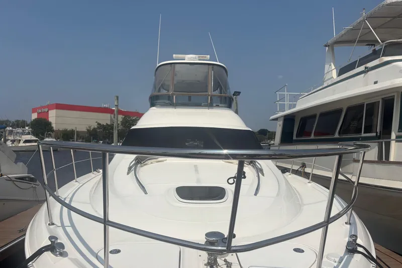 Slide: The Image of 2006 Sea Ray 52 Sedan Bridge yacht docked at marina, front view. - 2
