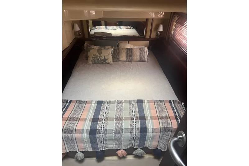 Slide: The Image of Cozy bedroom interior of 2006 Sea Ray 52 Sedan Bridge yacht with plaid bedding. - 31