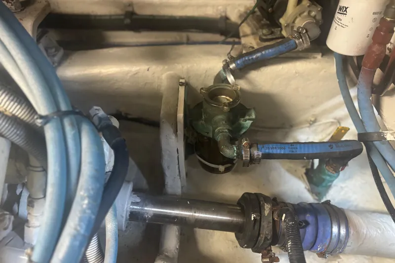 Slide: The Image of Engine room of 2006 Sea Ray 52 Sedan Bridge with visible hoses and components. - 38