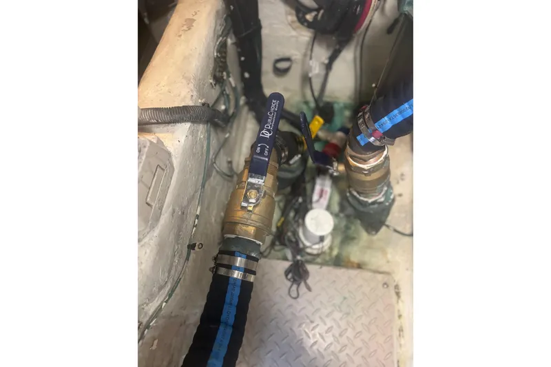 Slide: The Image of Engine room of 2006 Sea Ray 52 Sedan Bridge with plumbing and valves. - 43