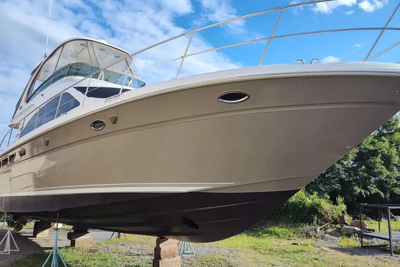Slide: The Image of 2006 Sea Ray 52 Sedan Bridge yacht on stands, under a clear blue sky. - 48