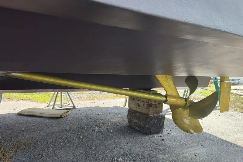 Slide: The Image of 2006 Sea Ray 52 Sedan Bridge propeller and shaft detail, displayed on a boatyard stand. - 52