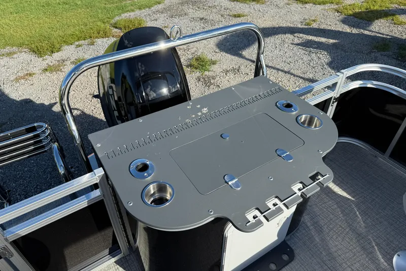 Slide: The Image of 2026 Avalon Venture 85 Rear Fish boat with fishing station and motor, on gravel and grass. - 6