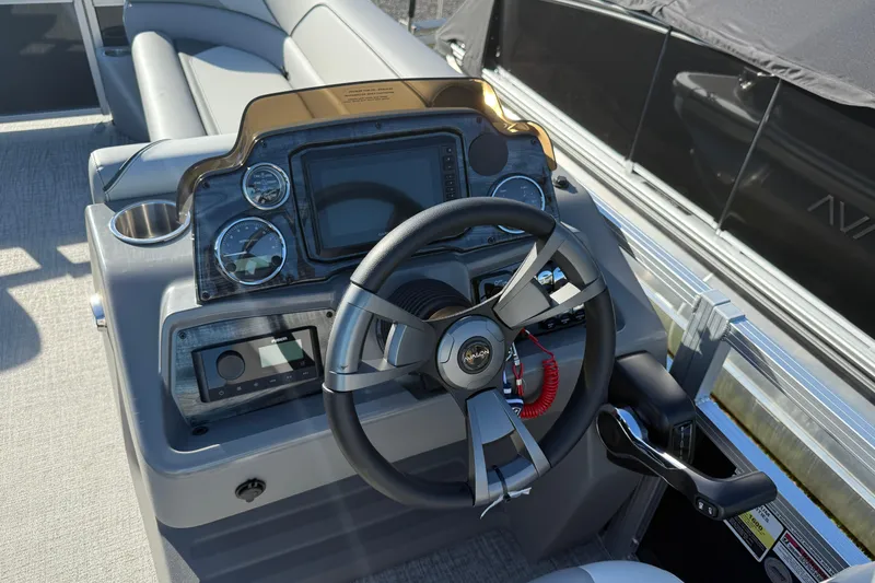 Slide: The Image of 2026 Avalon Venture 85 Rear Fish boat dashboard with steering wheel and control panel. - 7