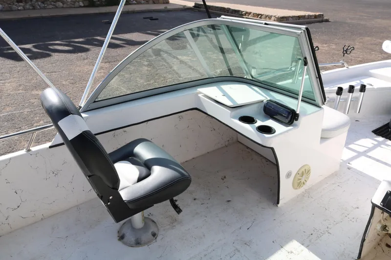 Slide: The Image of Interior of 2008 Blue Wave 220 Deluxe Pro boat with seating and console. - 13