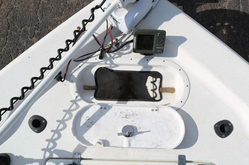 Slide: The Image of 2008 Blue Wave 220 Deluxe Pro boat deck with electronics and storage compartment. - 22