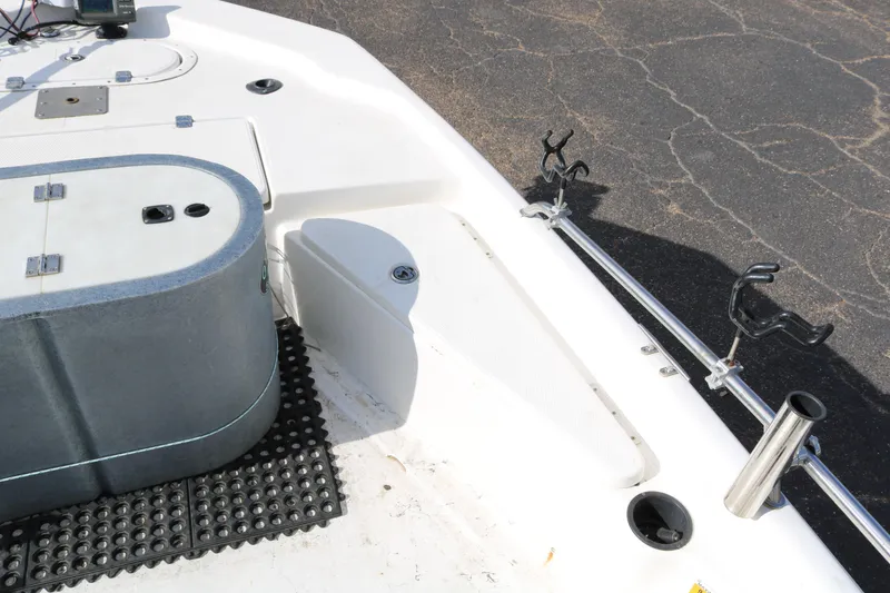 Slide: The Image of 2008 Blue Wave 220 Deluxe Pro boat interior with rod holders and storage compartments. - 24