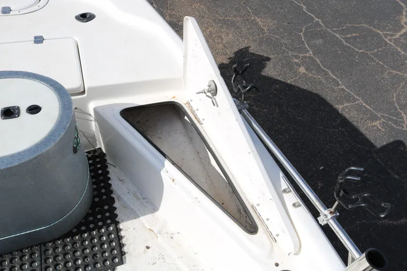 Slide: The Image of 2008 Blue Wave 220 Deluxe Pro boat interior with open storage compartment and rod holders. - 25