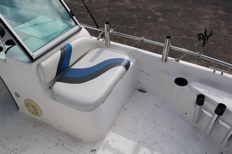 Slide: The Image of 2008 Blue Wave 220 Deluxe Pro boat interior with cushioned seating and rod holders. - 28