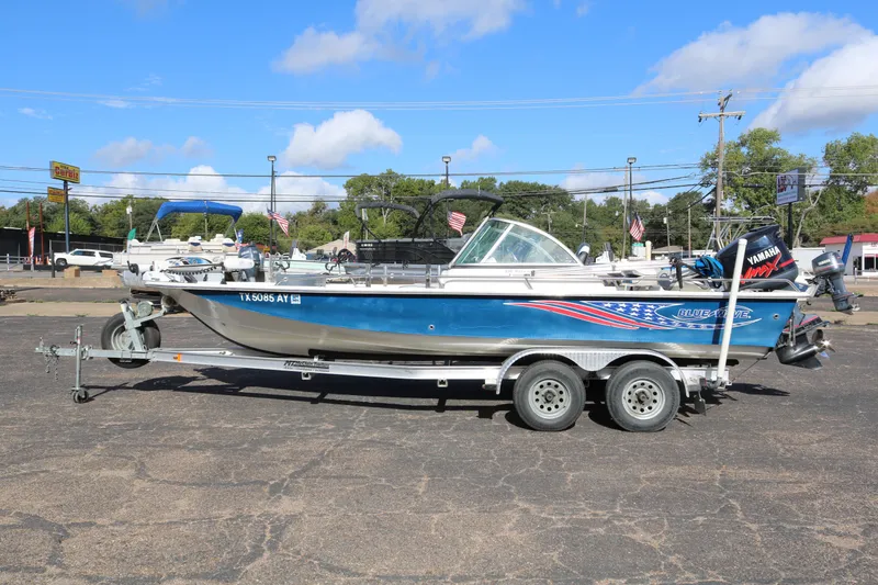 Slide: The Image of 2008 Blue Wave 220 Deluxe Pro boat on trailer, parked outdoors under blue sky. - 3