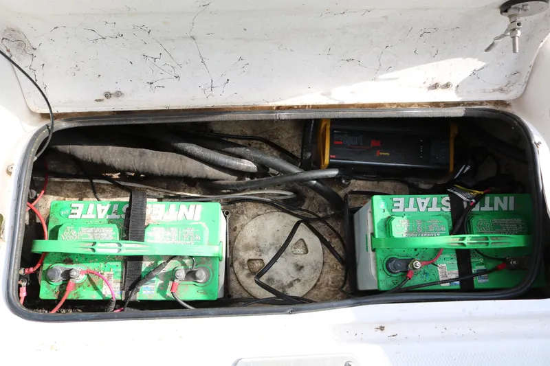 Slide: The Image of 2008 Blue Wave 220 Deluxe Pro boat battery compartment with Interstate batteries and wiring. - 31