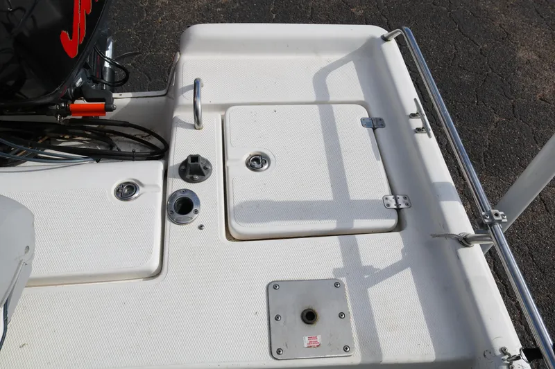 Slide: The Image of 2008 Blue Wave 220 Deluxe Pro boat deck with storage compartments and railing. - 32