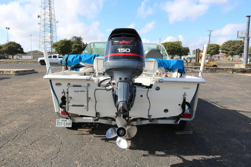 Slide: The Image of 2008 Blue Wave 220 Deluxe Pro boat with Yamaha 150 outboard motor in parking lot. - 5
