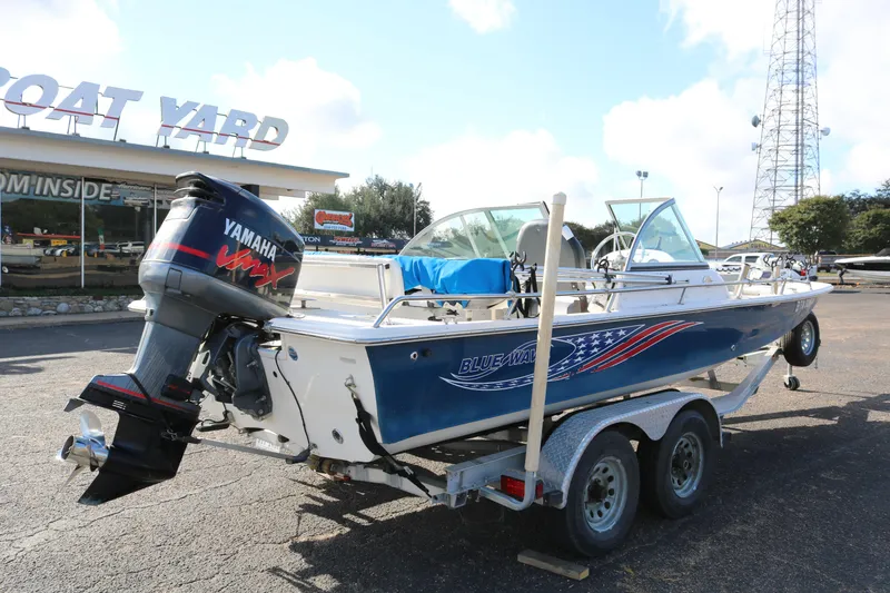 Slide: The Image of 2008 Blue Wave 220 Deluxe Pro boat on trailer at dealership, featuring Yamaha outboard motor. - 6