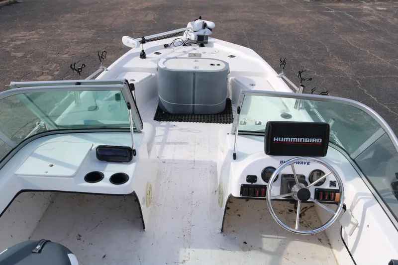 Slide: The Image of 2008 Blue Wave 220 Deluxe Pro boat interior with steering wheel and Humminbird system. - 9