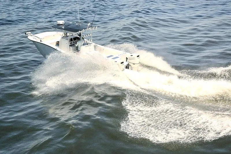 Slide: The Image of 2020 AmeraCat 27cc boat cruising swiftly on open water. - 1