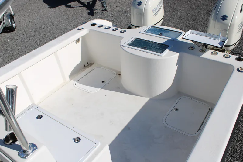 Slide: The Image of 2020 AMERICAT 27cc boat interior with dual Suzuki engines, spacious deck, and storage compartments. - 12