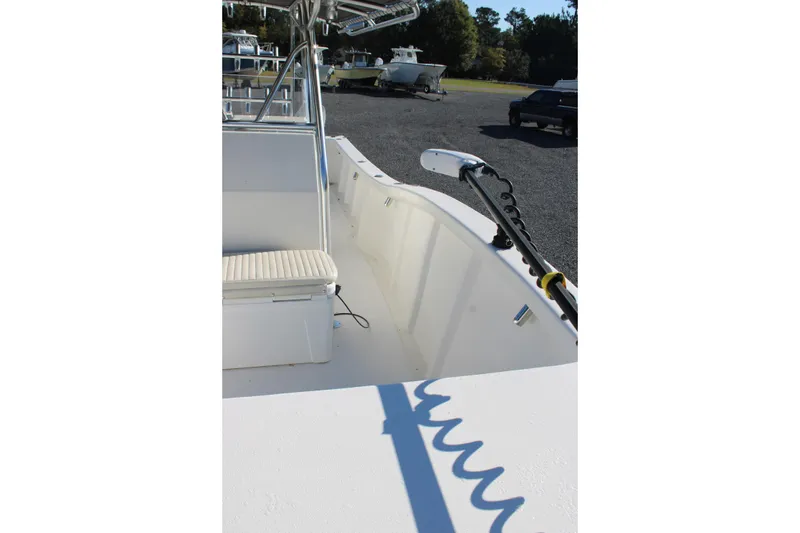Slide: The Image of 2020 AMERICAT 27cc boat interior with seating and equipment, parked outdoors. - 14