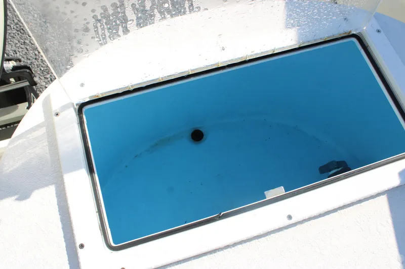 Slide: The Image of Open storage compartment on 2020 AMERICAT 27cc boat, featuring a blue interior. - 21