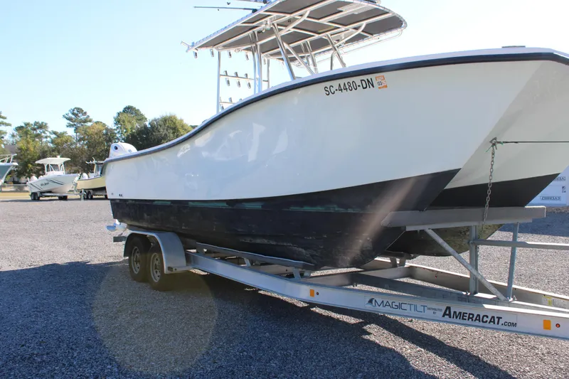 Slide: The Image of 2020 AMERICAT 27cc boat on trailer in outdoor setting. - 7