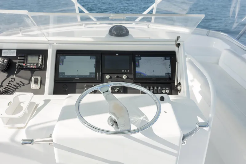 Slide: The Image of Helm of 2000 Hatteras 50 Convertible yacht with navigation equipment and steering wheel. - 10