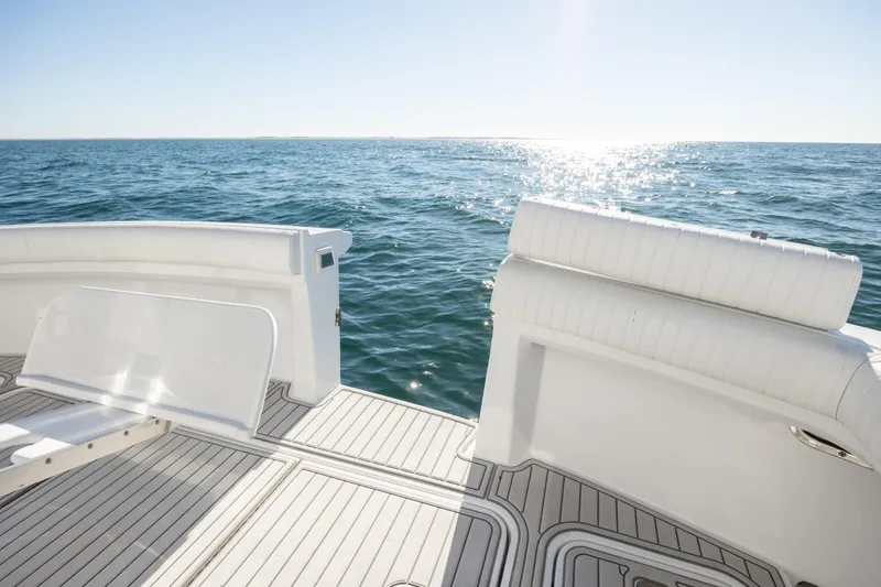 Slide: The Image of Hatteras 50 Convertible 2000 yacht deck with ocean view and sunlight reflections. - 24