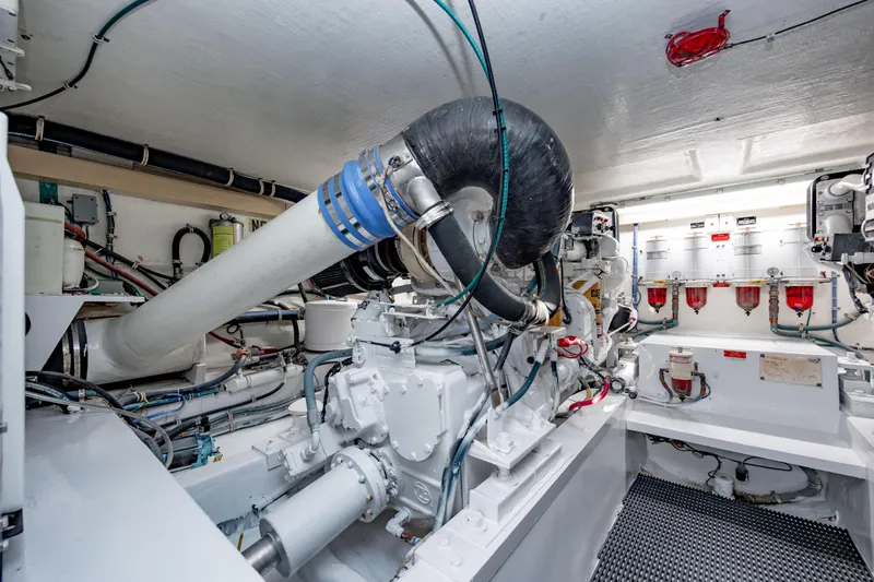 Slide: The Image of Engine room of 2000 Hatteras 50 Convertible yacht, showcasing machinery and components. - 35