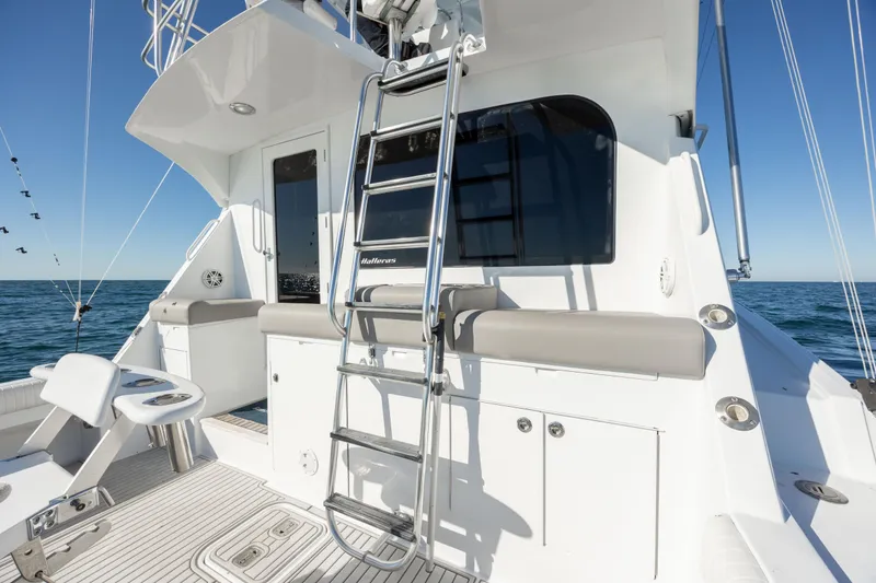 Slide: The Image of 2000 Hatteras 50 Convertible yacht with ladder and seating, on open water. - 25