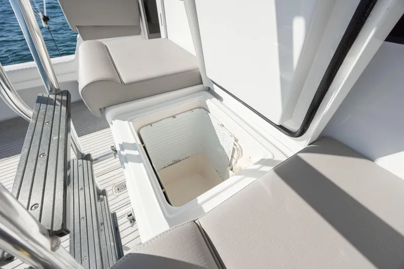 Slide: The Image of Open storage compartment on 2000 Hatteras 50 Convertible boat deck, with cushioned seating. - 30