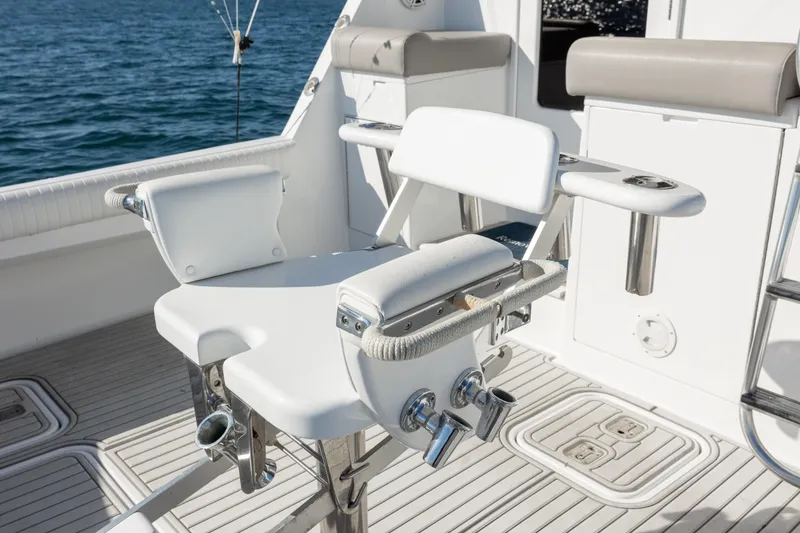 Slide: The Image of Fishing chair on 2000 Hatteras 50 Convertible yacht deck, overlooking ocean waters. - 31