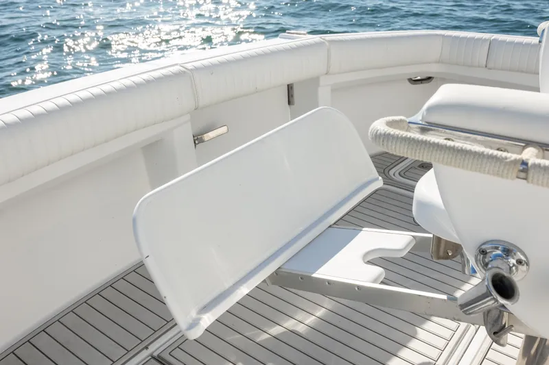 Slide: The Image of 2000 Hatteras 50 Convertible yacht deck with white seating and ocean view. - 32