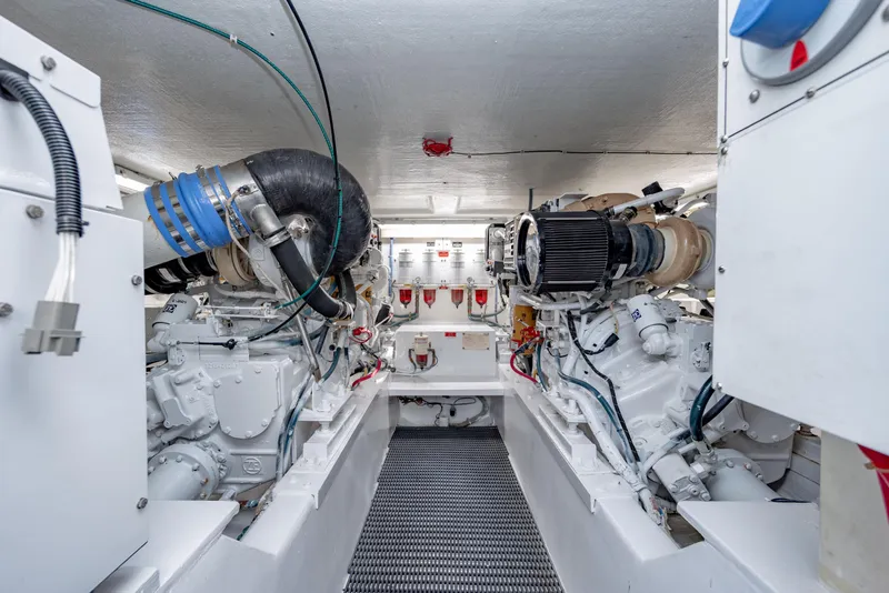 Slide: The Image of Engine room of 2000 Hatteras 50 Convertible yacht, showcasing dual engines and mechanical systems. - 34